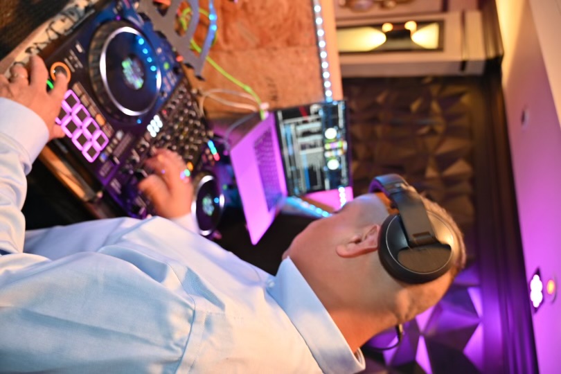 Professional DJ performing at event with equipment